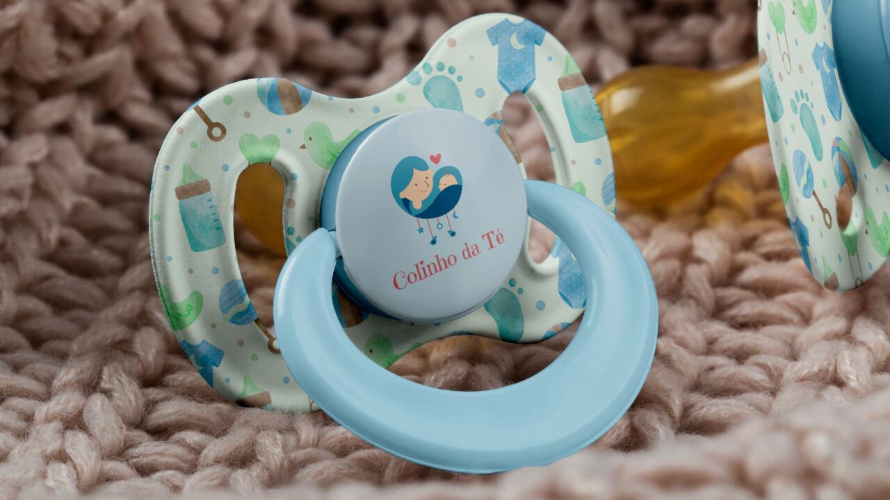 a baby pacifier sitting on top of a blanket make by adfstudio